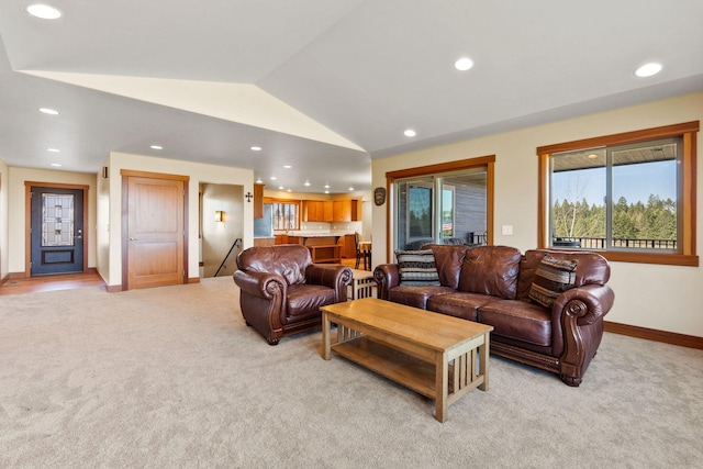 living room with baseboards, recessed lighting, lofted ceiling, and light colored carpet