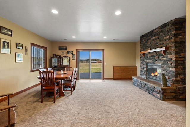 carpeted dining space featuring a fireplace, recessed lighting, and baseboards