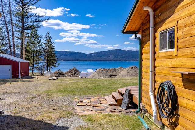 property view of water with a pole building and a mountain view