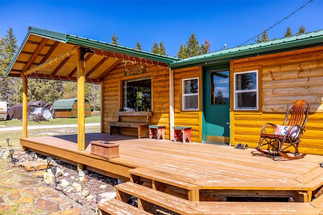 deck featuring a storage unit and an outdoor structure