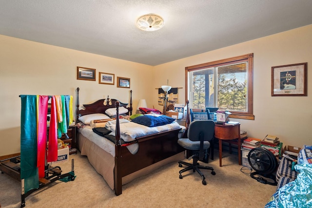 bedroom with a textured ceiling and light carpet