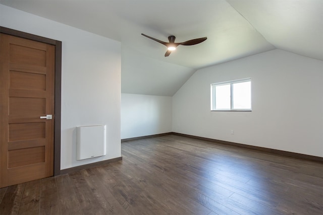 additional living space featuring baseboards, wood finished floors, ceiling fan, and vaulted ceiling