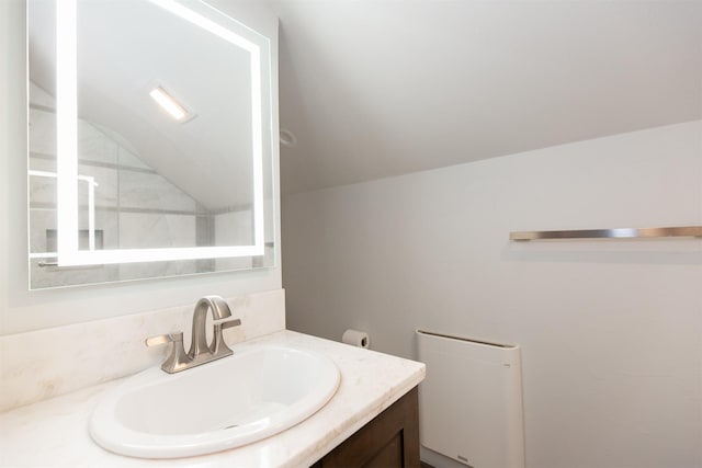 bathroom featuring lofted ceiling and vanity