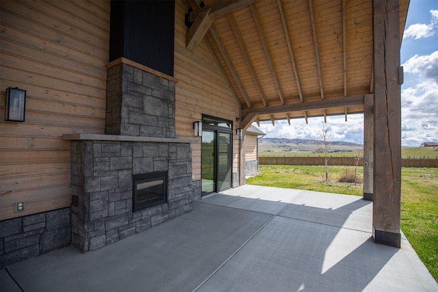 view of patio / terrace with fence and a mountain view