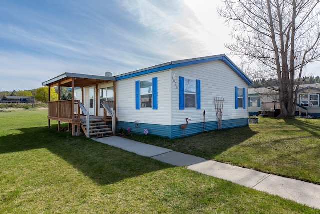 view of front of home with a wooden deck and a front lawn