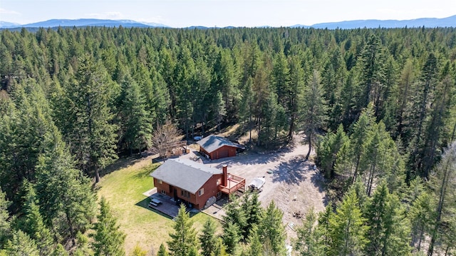 birds eye view of property featuring a mountain view and a forest view