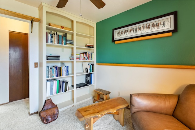 sitting room featuring ceiling fan and carpet floors