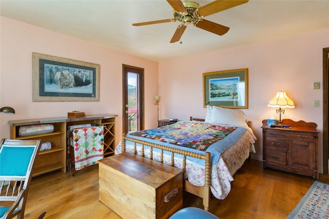 bedroom featuring access to exterior, ceiling fan, and wood finished floors