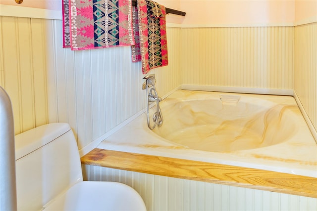 bathroom with toilet and a bath