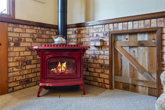details featuring a wood stove and carpet floors