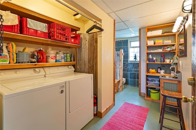 washroom featuring washer and clothes dryer, laundry area, and a sink