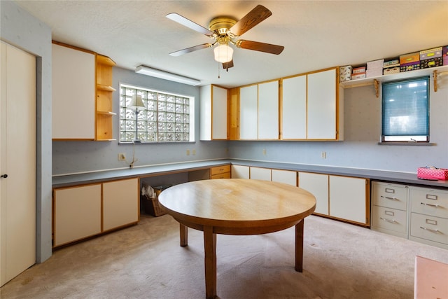kitchen featuring ceiling fan, white cabinets, open shelves, and light colored carpet