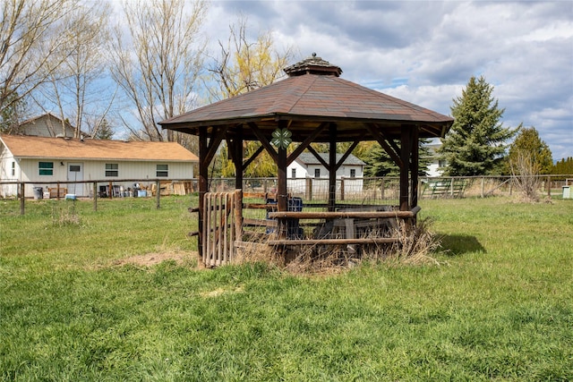 view of home's community featuring fence, a gazebo, and a lawn