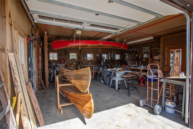 garage with a workshop area and a garage door opener
