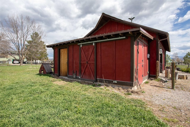 view of outdoor structure with an outbuilding and fence