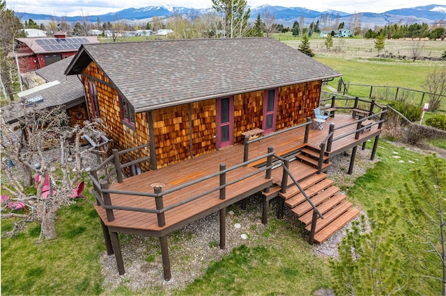 wooden deck with a lawn and a mountain view
