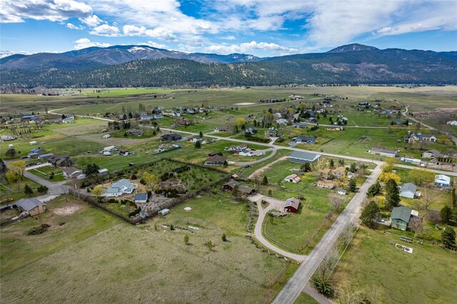 birds eye view of property with a mountain view and a rural view
