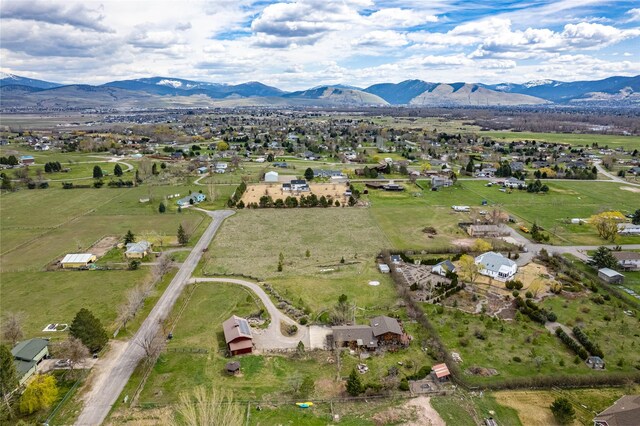 7850 Stegner Dr, Missoula, MT 59808 - view of front of home featuring solar panels, gravel driveway, a metal roof, a chimney, and an outdoor structure