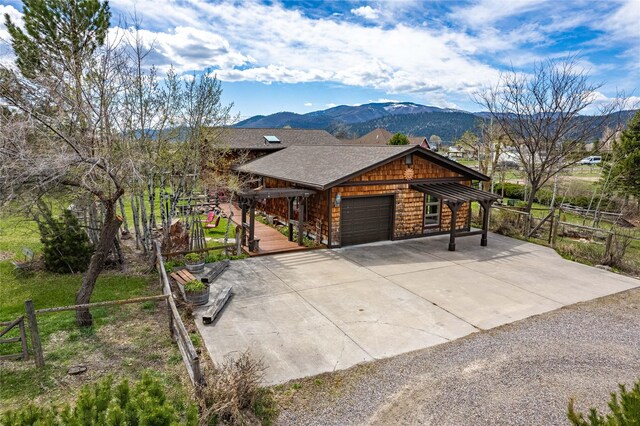7850 Stegner Dr, Missoula, MT 59808 - rustic home with a garage, a mountain view, driveway, and roof with shingles