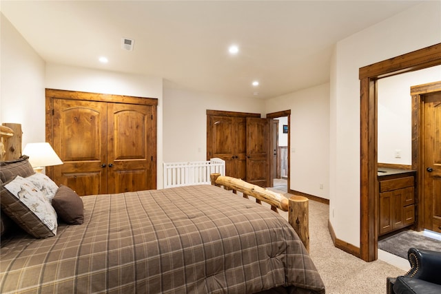 carpeted bedroom featuring recessed lighting, visible vents, and baseboards