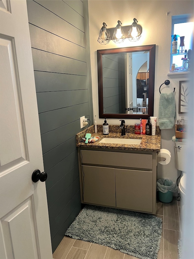69571 Big Sam Ln, Arlee, MT 59821 - bathroom featuring wood tiled floors, vanity, and toilet