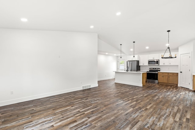 1503 3rd Ave NW, Great Falls, MT 59404 - kitchen featuring appliances with stainless steel finishes, open floor plan, recessed lighting, dark wood-type flooring, and a center island with sink