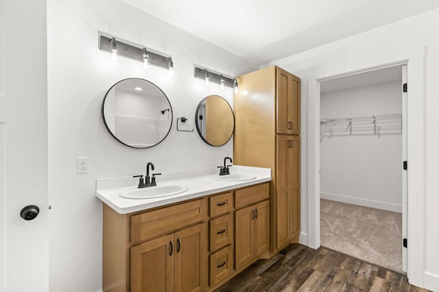 1503 3rd Ave NW, Great Falls, MT 59404 - bathroom featuring double vanity, wood finished floors, and a walk in closet