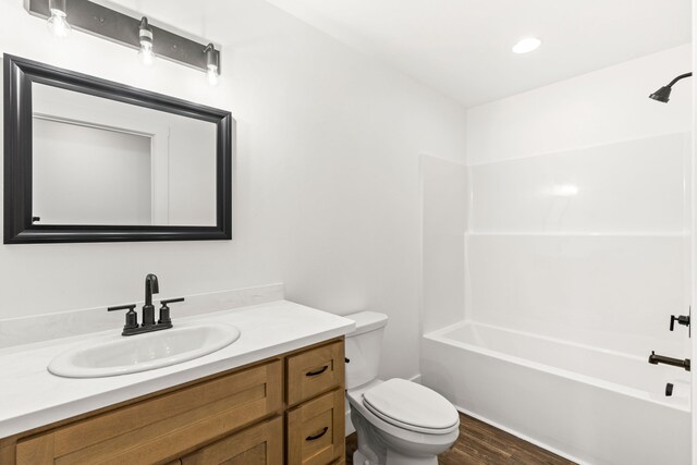 1503 3rd Ave NW, Great Falls, MT 59404 - bathroom with toilet, vanity, wood finished floors, and shower / tub combination
