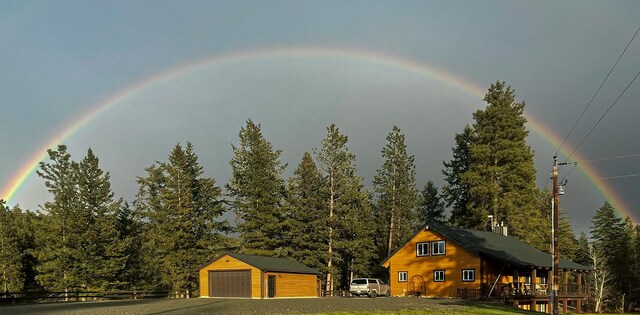 58386 Mt Highway 37, Rexford, MT 59930 - exterior space featuring a detached garage, an outbuilding, and view of wooded area