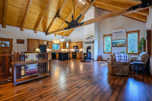 58386 Mt Highway 37, Rexford, MT 59930 - living area with an AC wall unit, a wood stove, high vaulted ceiling, wood ceiling, and dark wood-style floors