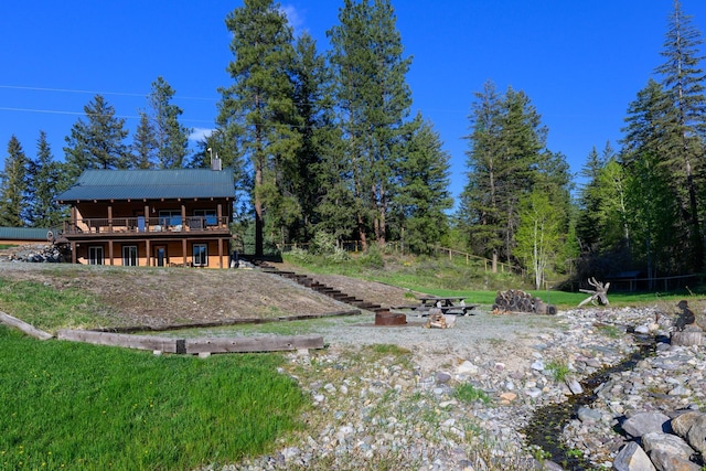 58386 Mt Highway 37, Rexford, MT 59930 - back of house featuring a deck, metal roof, and a chimney