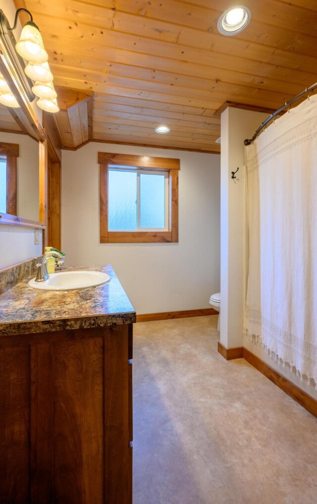58386 Mt Highway 37, Rexford, MT 59930 - bathroom with wood ceiling, toilet, vanity, baseboards, and healthy amount of natural light