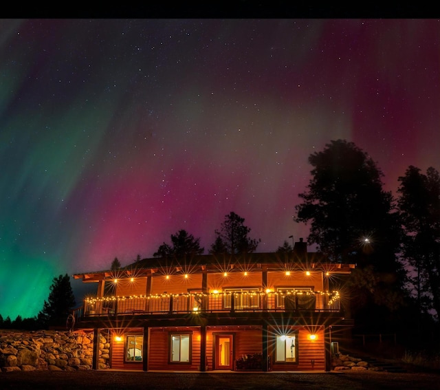 58386 Mt Highway 37, Rexford, MT 59930 - back of house at twilight featuring a balcony