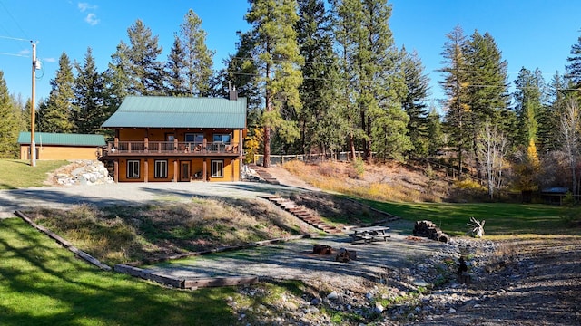 58386 Mt Highway 37, Rexford, MT 59930 - back of house featuring a deck, a lawn, a chimney, and stairs
