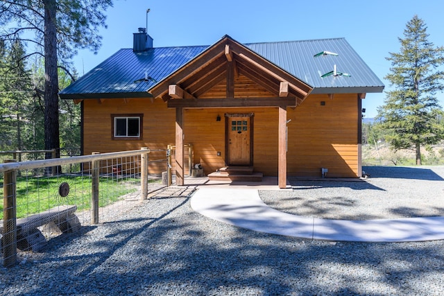 58386 Mt Highway 37, Rexford, MT 59930 - chalet / cabin with a chimney, metal roof, and fence