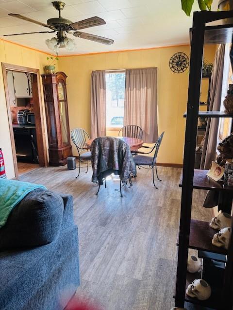 dining room with a ceiling fan and wood finished floors