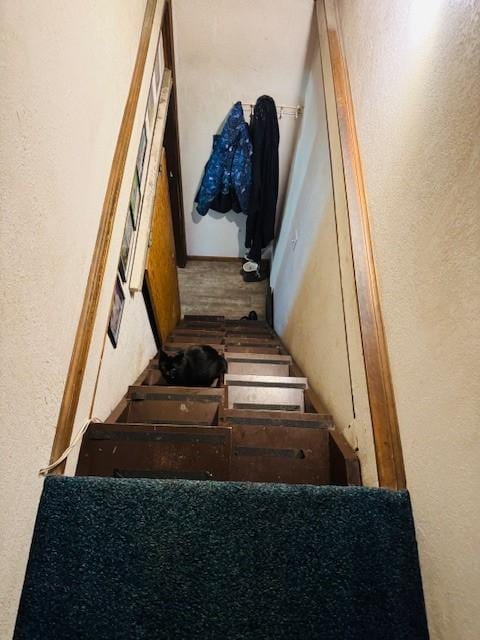 stairs featuring a textured wall