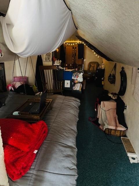 bedroom featuring a textured ceiling and vaulted ceiling