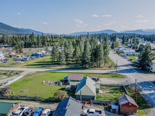 drone / aerial view with a mountain view and a forest view
