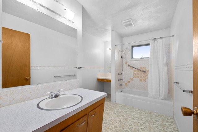 bathroom featuring visible vents, shower / bath combo, and vanity