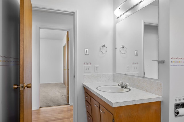 bathroom featuring wood finished floors and vanity