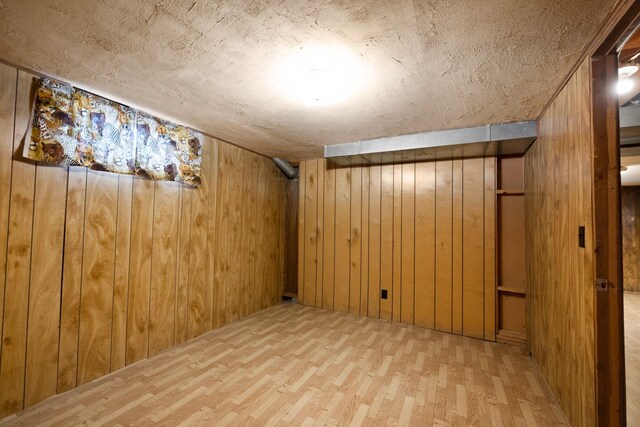finished basement with wood walls and wood finished floors