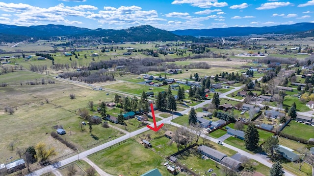 drone / aerial view featuring a mountain view and a rural view