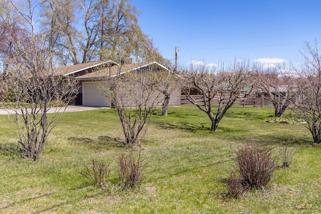 ranch-style home with a front yard, driveway, and an attached garage