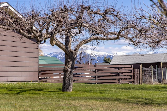 view of yard featuring a mountain view and fence