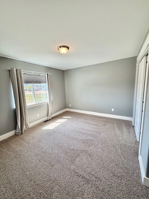 3554 Fasbender Ct, Helena, MT 59602 - unfurnished bedroom featuring carpet and baseboards