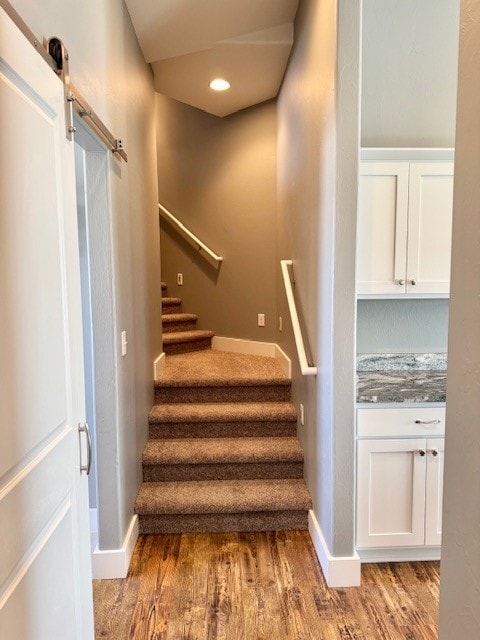 3554 Fasbender Ct, Helena, MT 59602 - staircase with wood finished floors, a barn door, baseboards, and recessed lighting