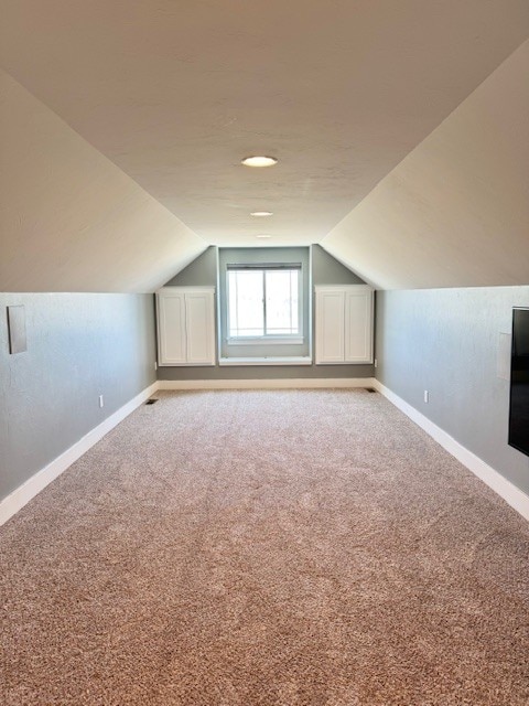 3554 Fasbender Ct, Helena, MT 59602 - bonus room featuring baseboards, lofted ceiling, and carpet flooring