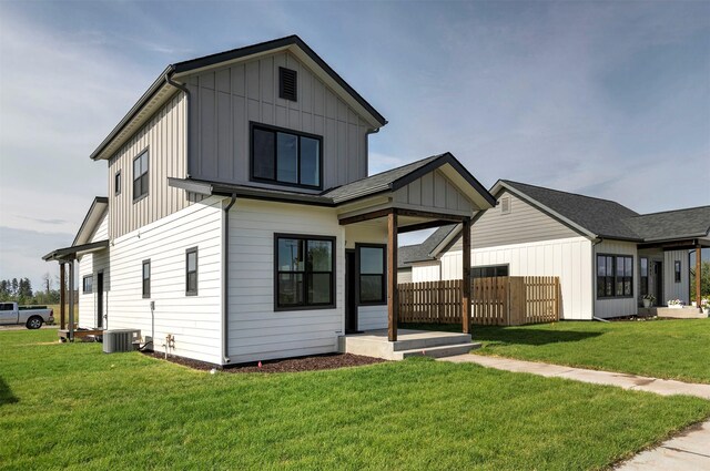 4961 England Blvd, Missoula, MT 59808 - back of property with board and batten siding, a shingled roof, and a yard