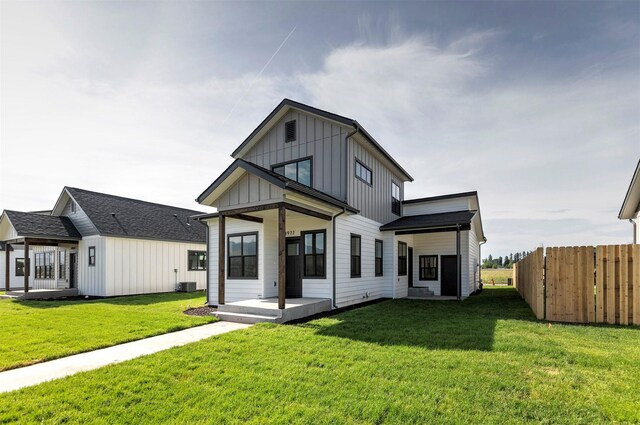 4961 England Blvd, Missoula, MT 59808 - view of front facade featuring concrete driveway, a front yard, board and batten siding, and a garage